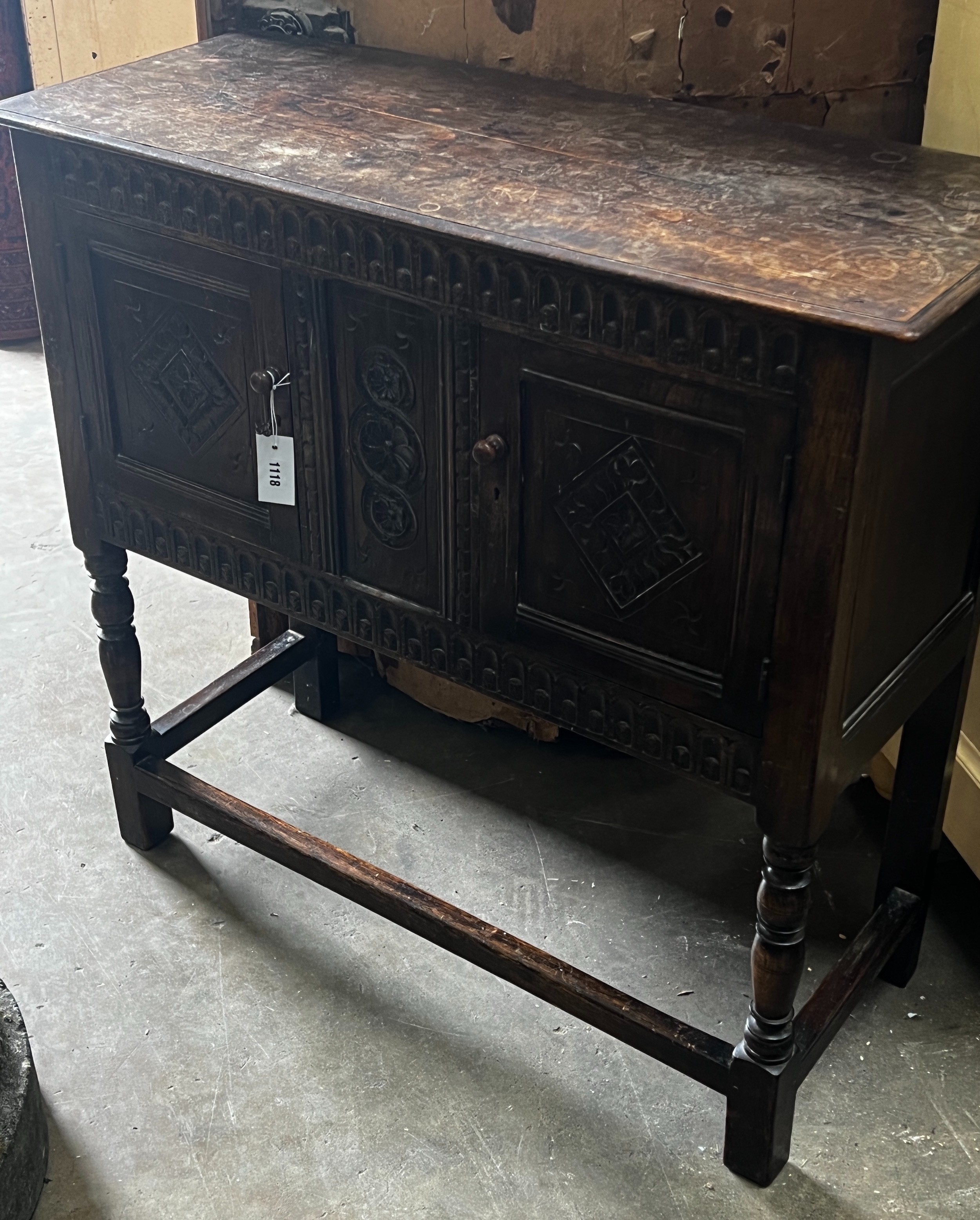 An 18th century style carved oak side cabinet, width 94cm depth 40cm height 88cm